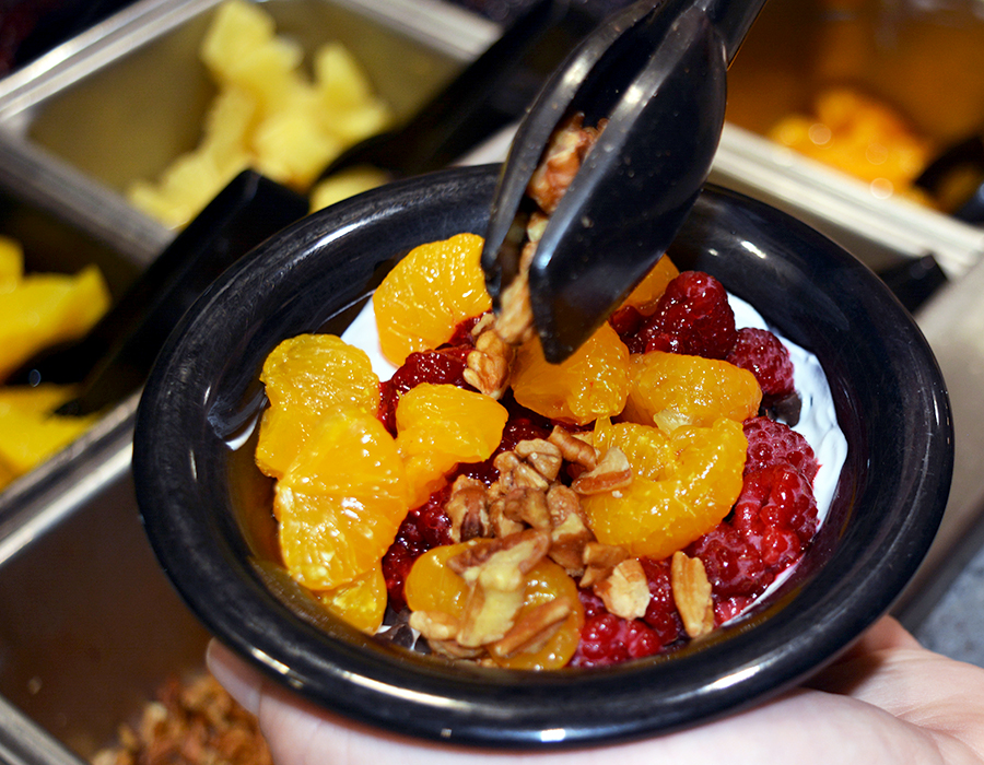 Bowl of yogurt and fruit toppings.