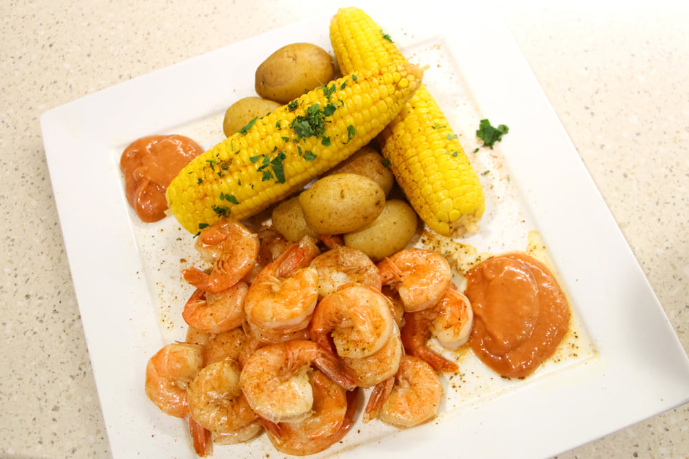 Peel-and-eat shrimp with corn and potatoes.